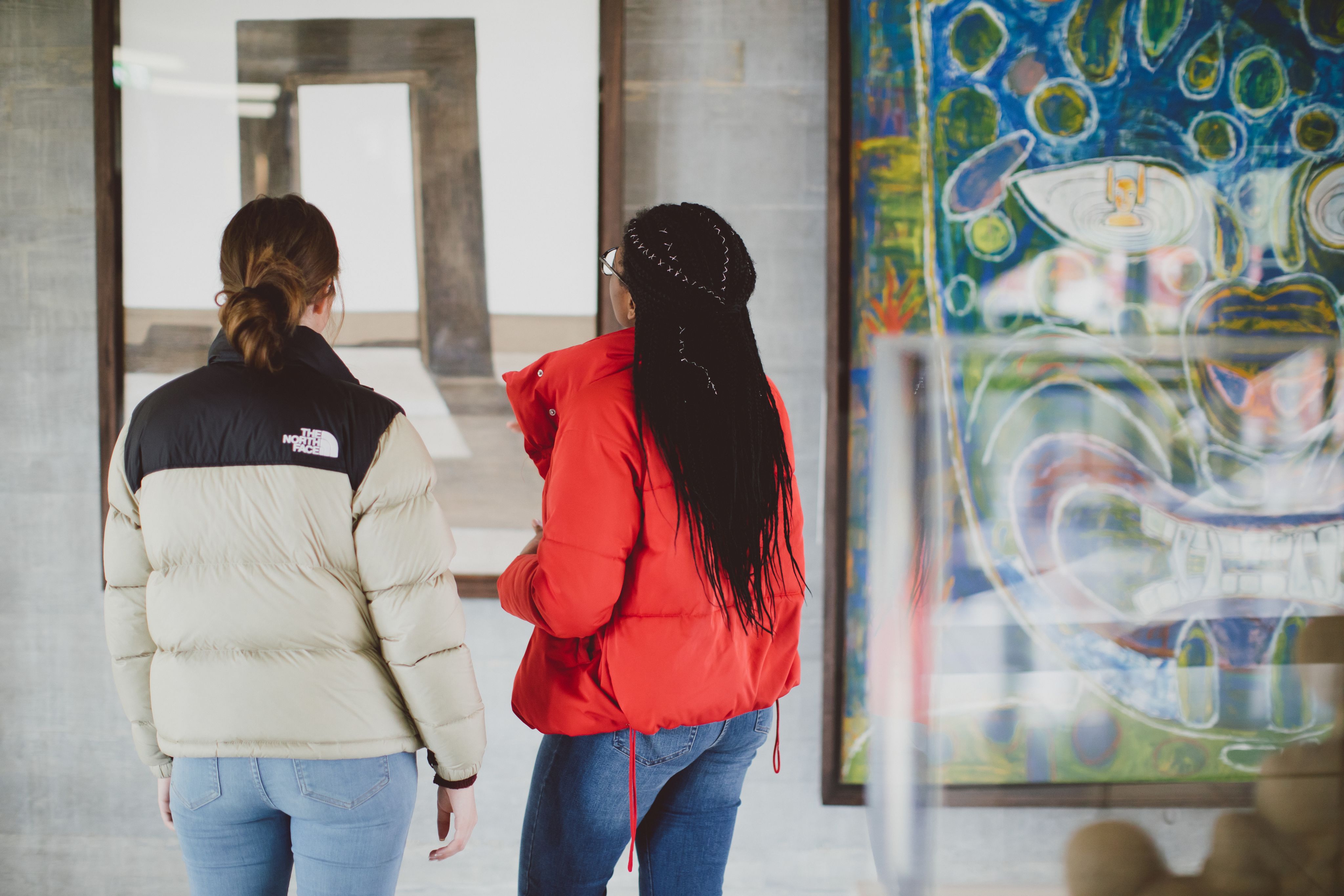 Two students looking at a piece of art.