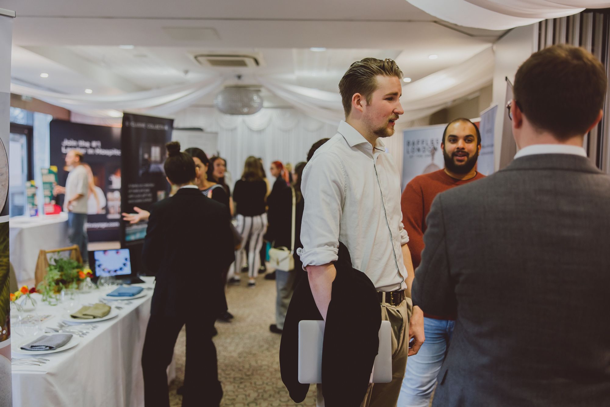 Young hospitality professionals chatting at a conference