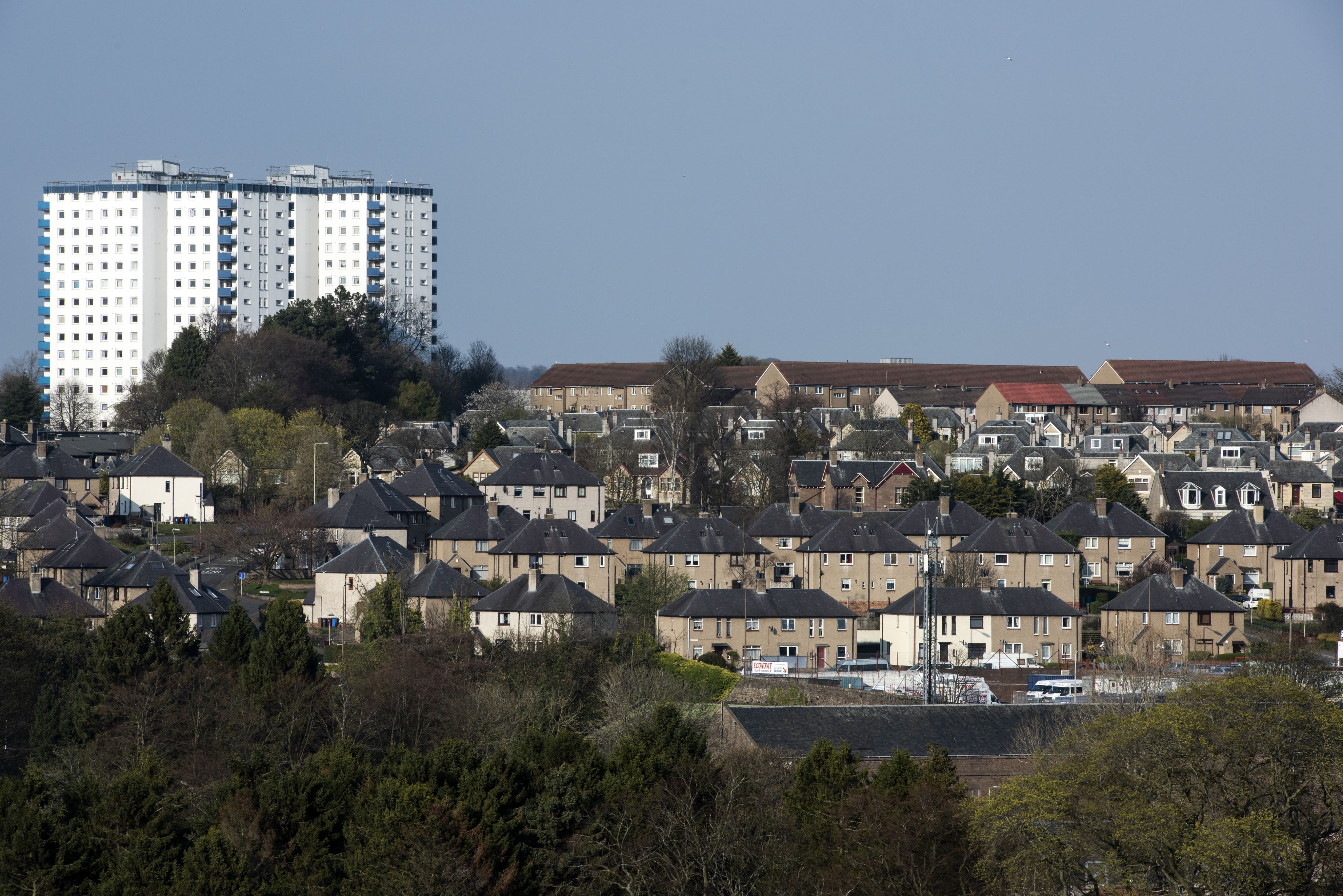 Photo looking across a series of houses to a tower block in the distances