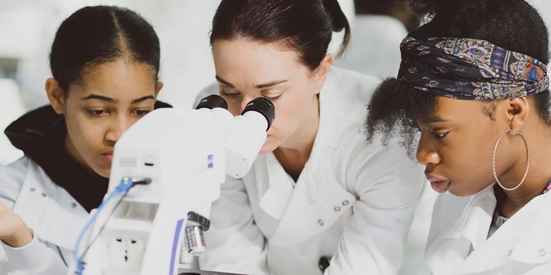 Students looking through a microscope