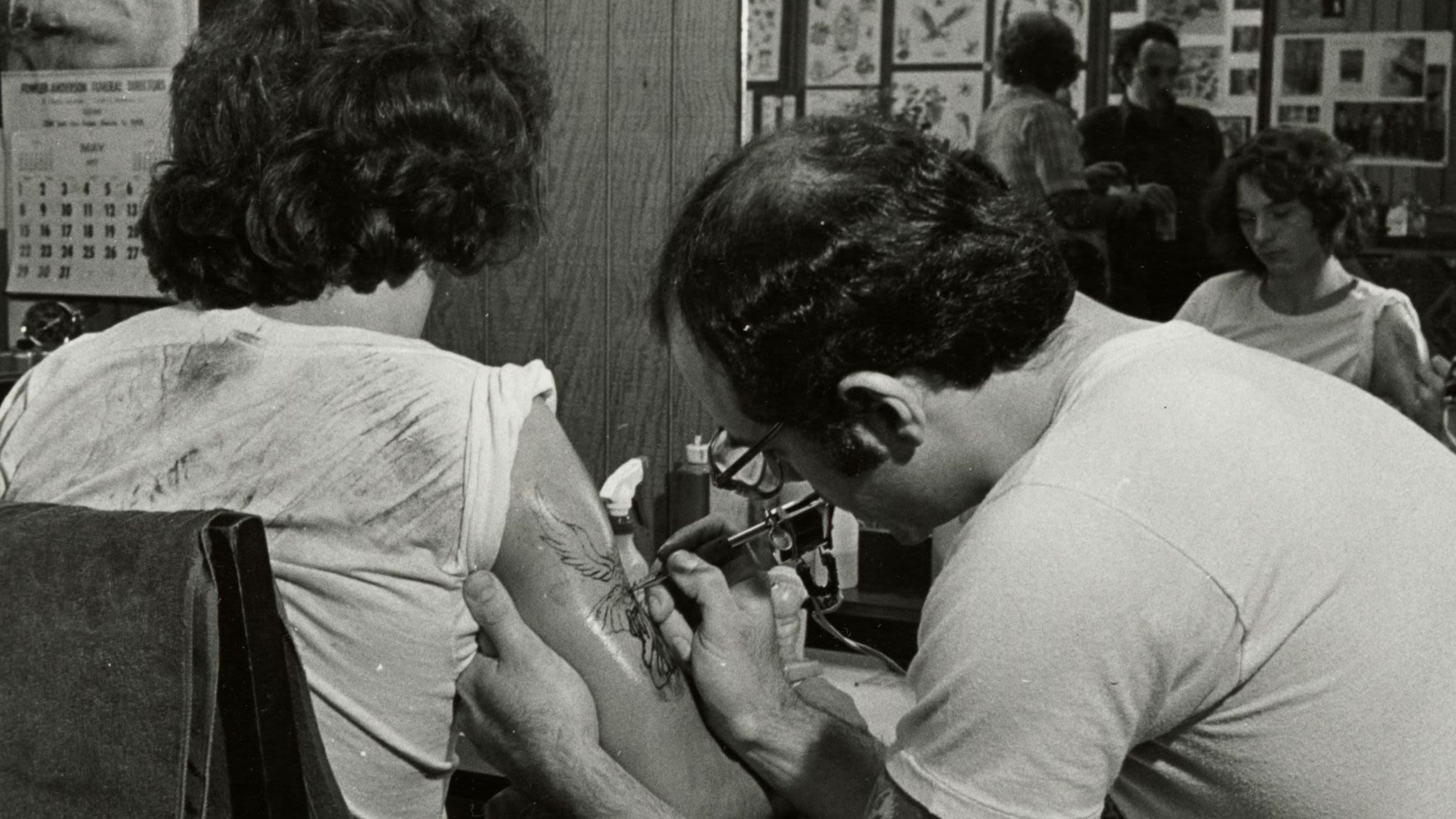 A tattoo artist working in the 1970s, courtesy of Oakland Museum of California