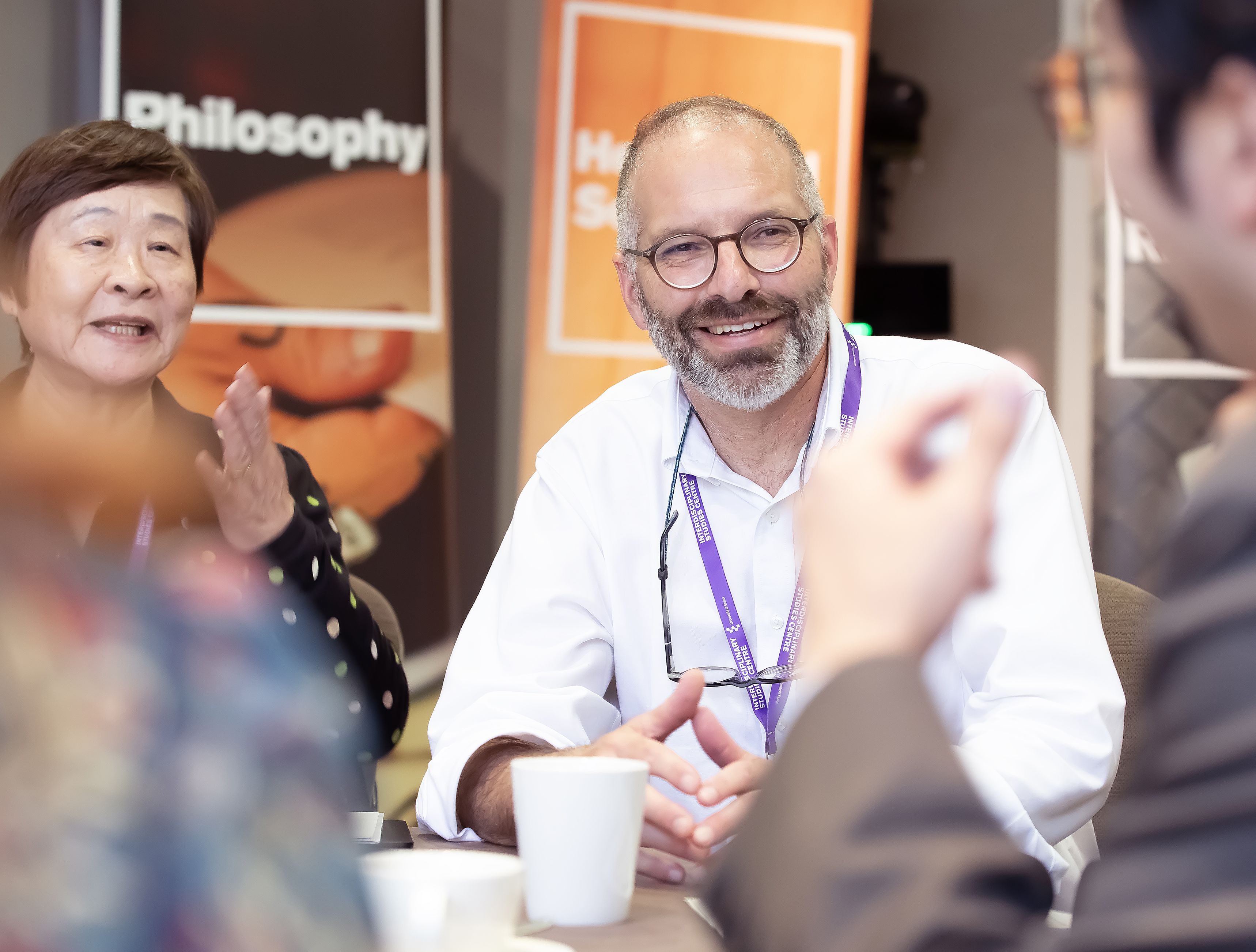 Professor Wayne Martin, smiling, mid-conversation