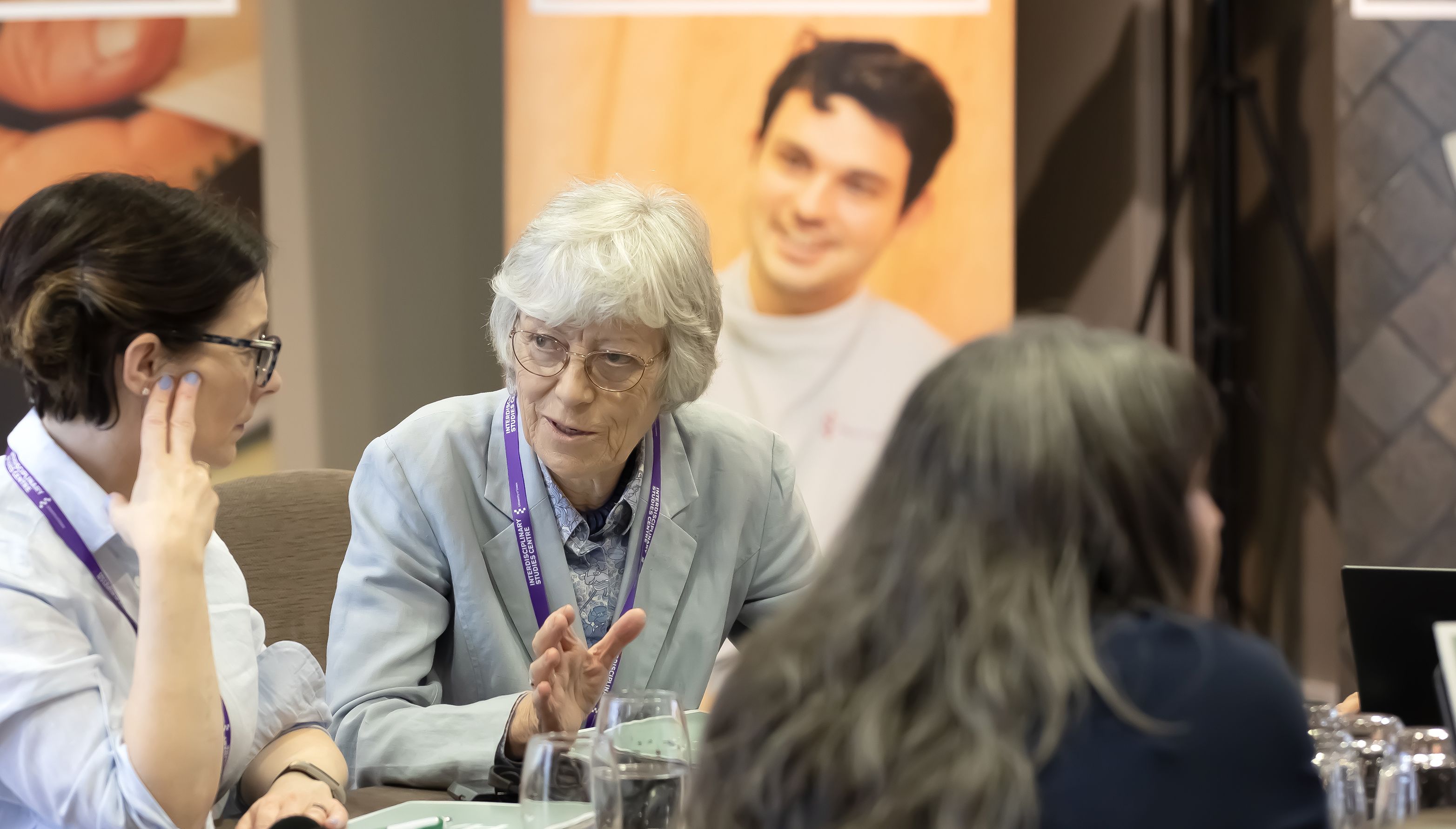 Two professional looking women in conversation at a conference