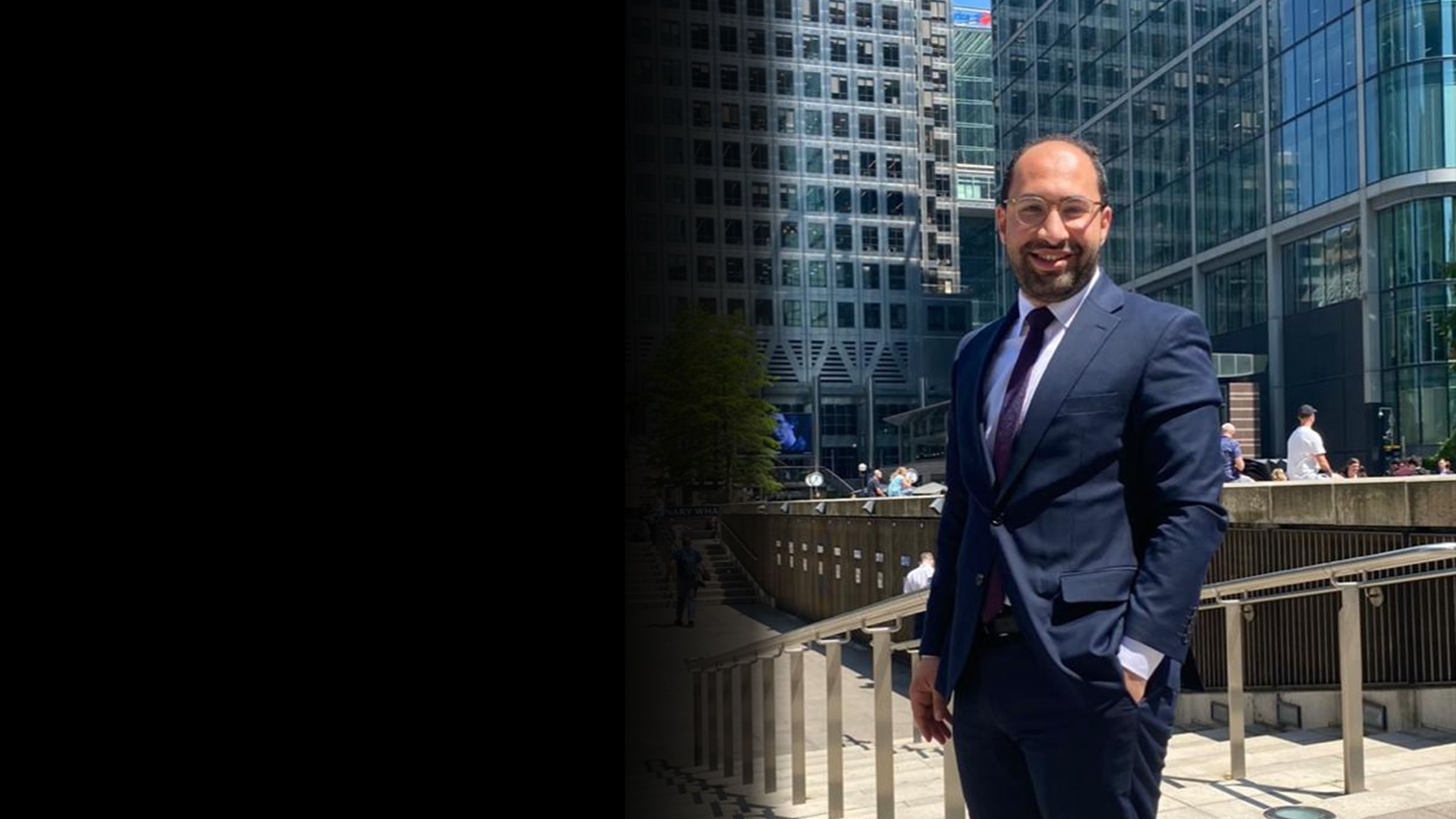 Marwan Yughi standing in front of office tower blocks