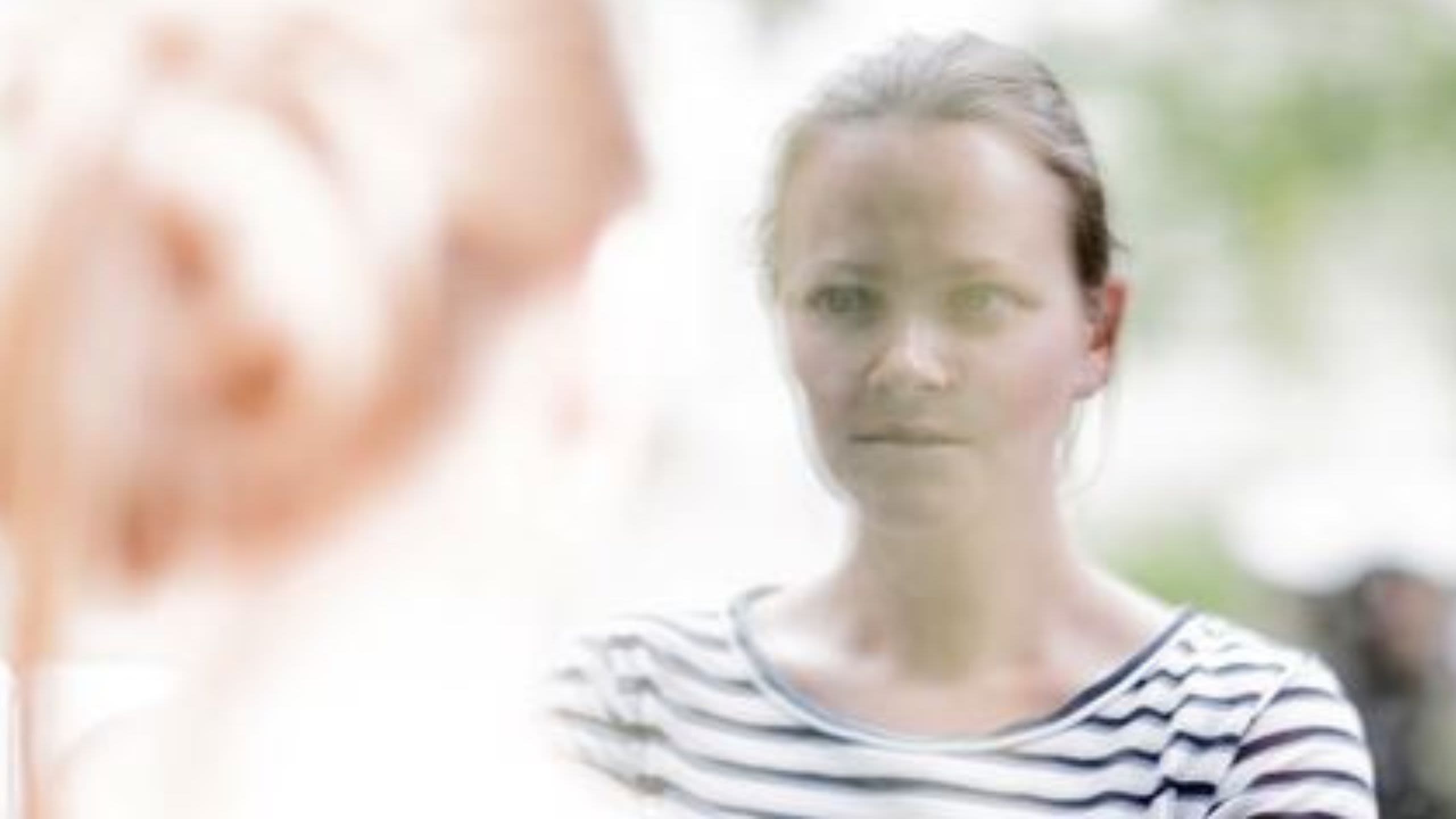 Woman looking through window