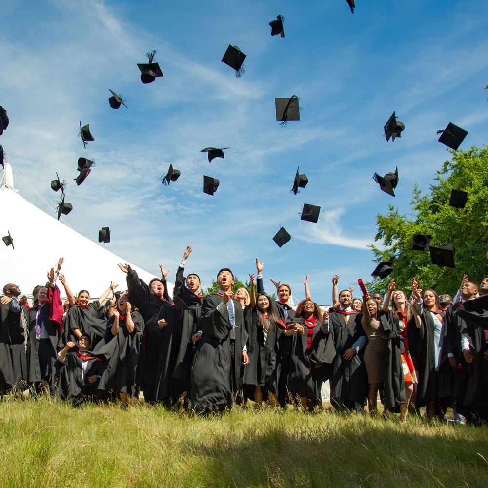 Students at their graduation throwing their caps into the air