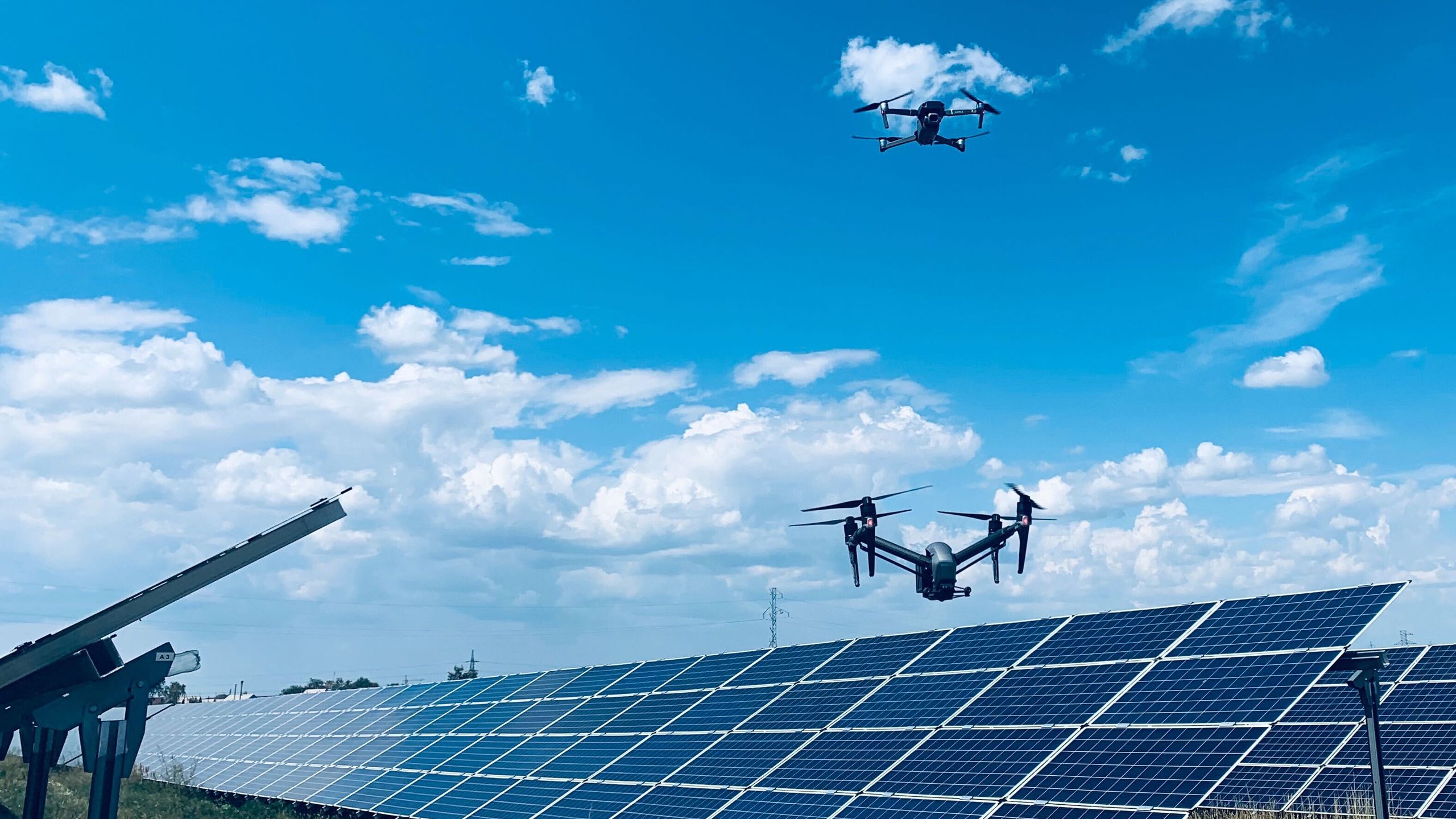 Drones flying over a solar farm