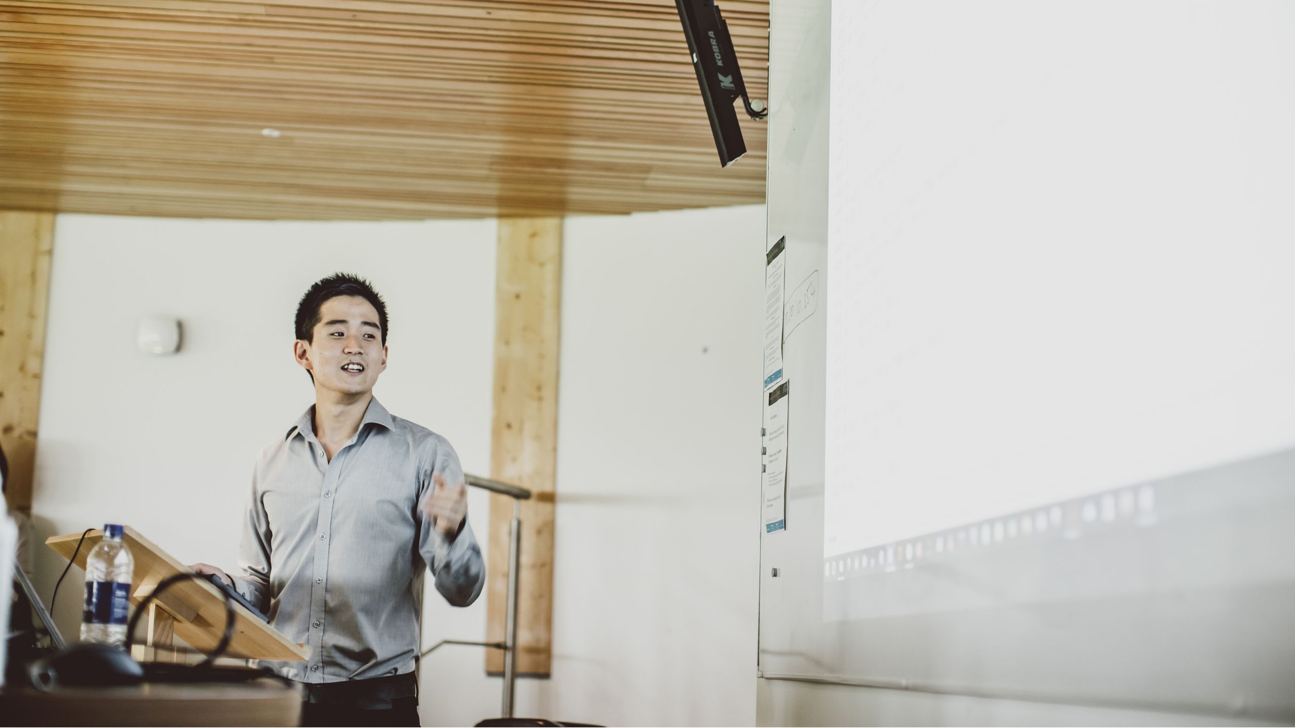 Man at lectern giving a lecture
