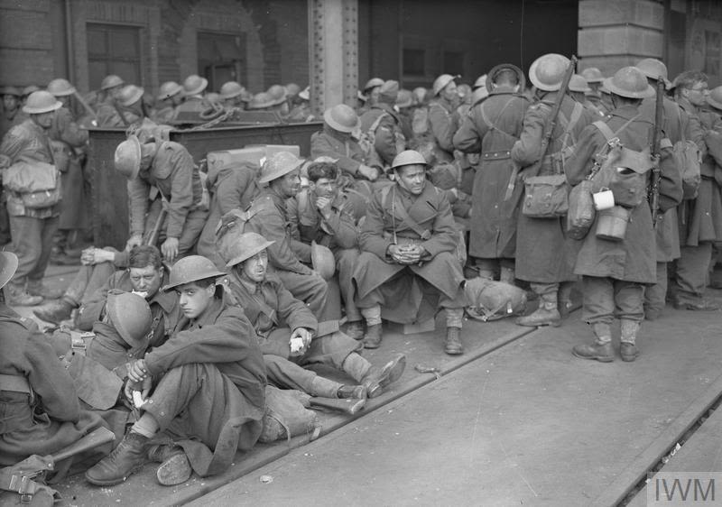 Archive photo of exhausted looking soldiers, wearing tin hats and overcoats, courtesy of the Imperial War Museum