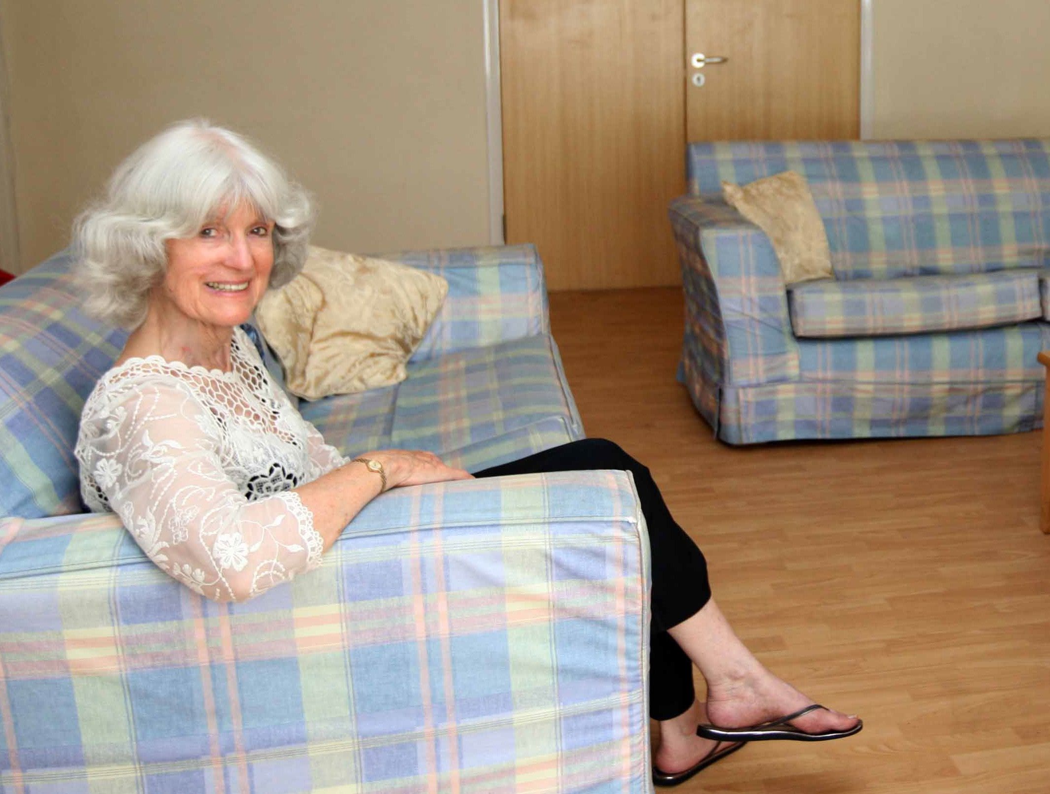 June Freeman sitting on a sofa in the living room