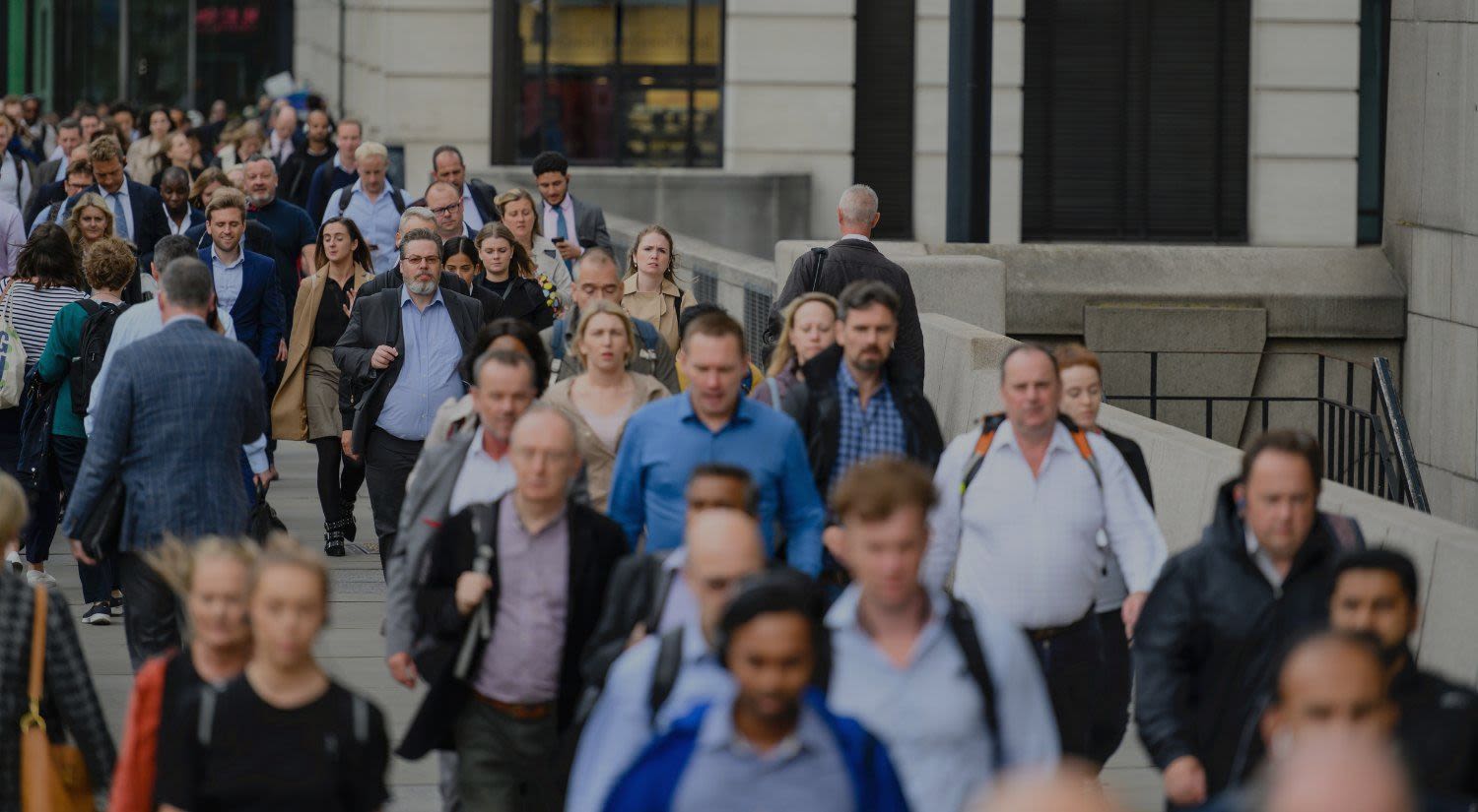 A crowd of people walking through a city centre