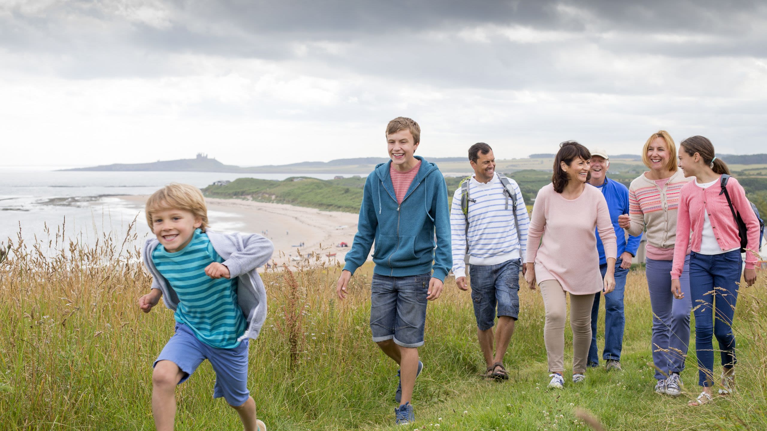 A family group walking along a clifftop