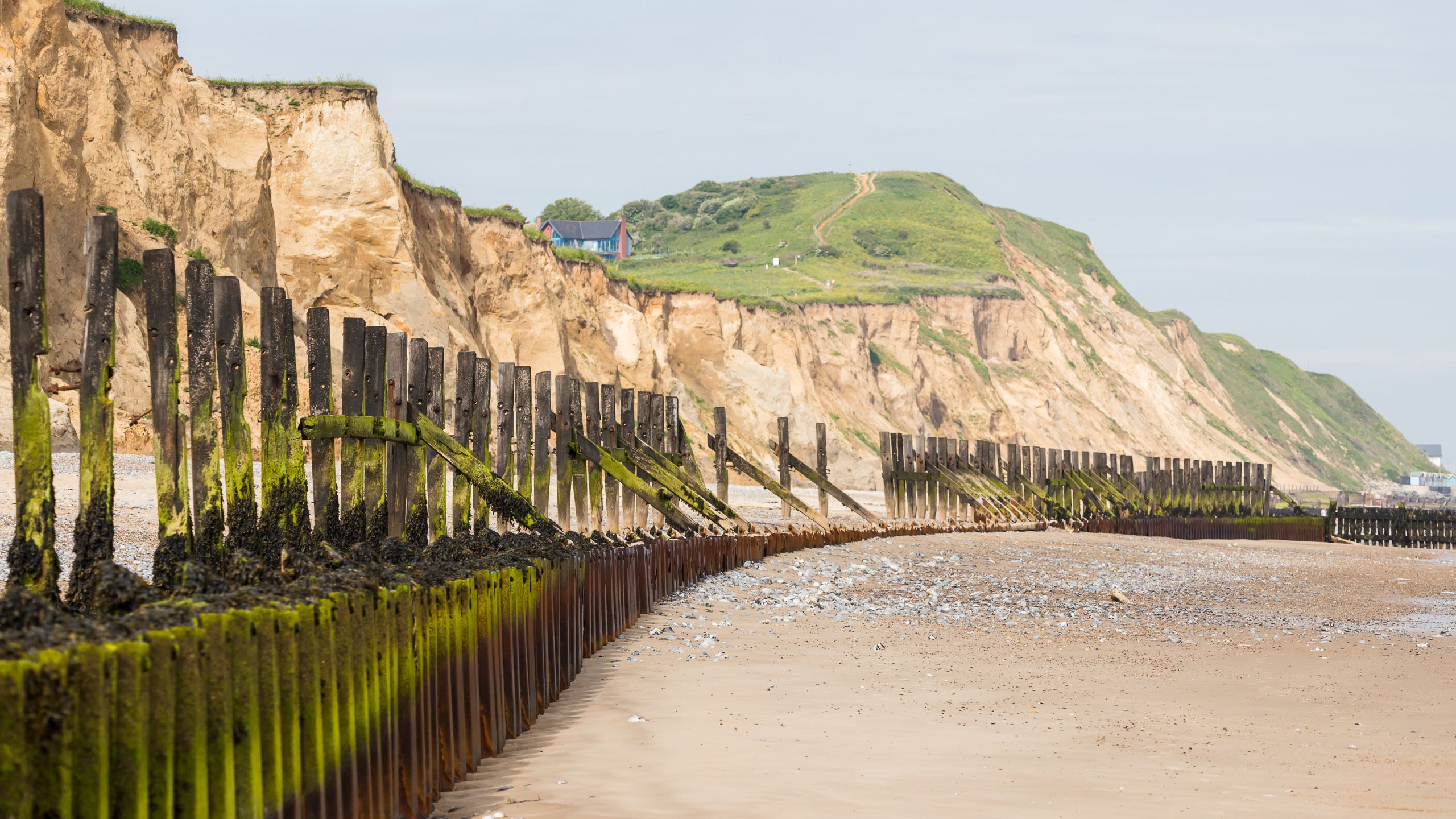 Norfolk coastal cliffs with sea defences in the foreground