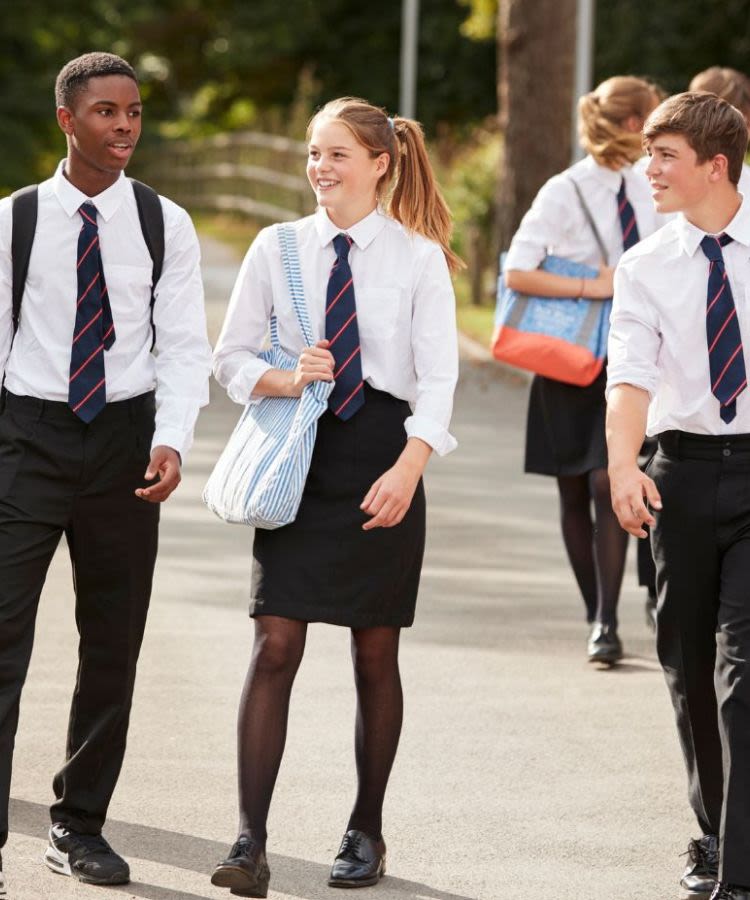 Teenage schoolchildren walking along in uniform