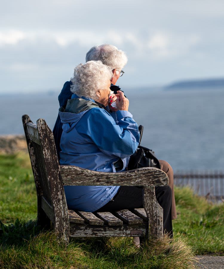 Two female pensioners sitting on a bench