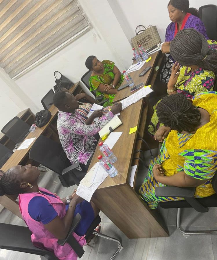 People sitting around table in workshop