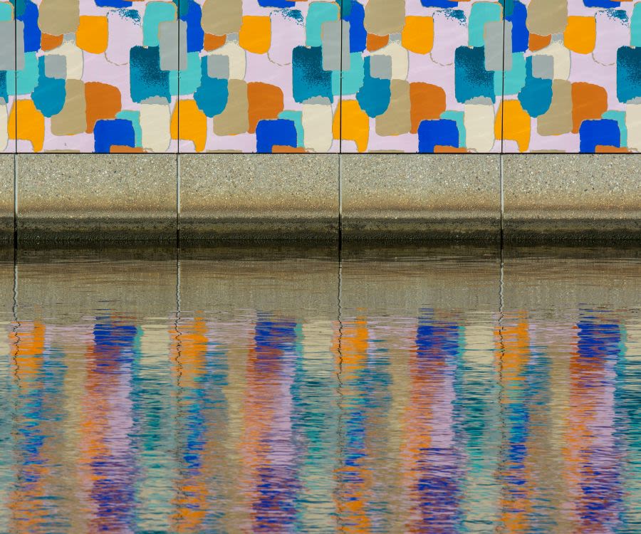 Wall art reflected in water