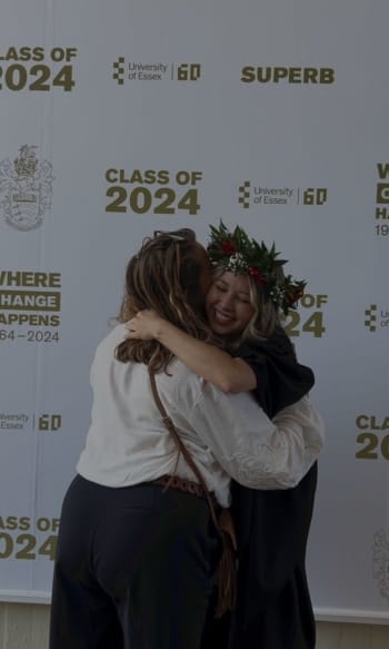Lily-May hugging her mum dressed in her graduation robes